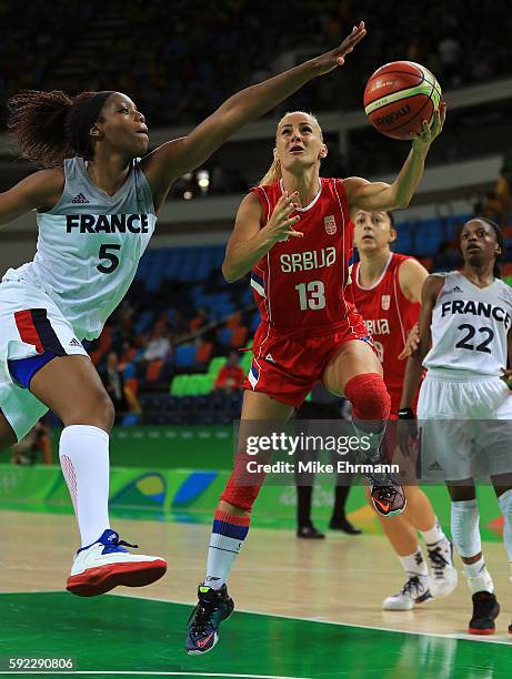 Milica Dabovic of Serbia works against Endy Miyem of France during the Women's Bronze Medal basketball game between France and Serbia on Day 15 of...