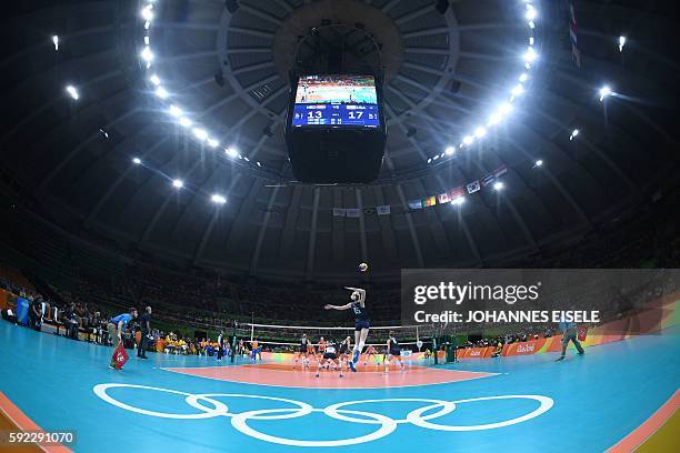 General view shows USA's Kimberly Hill serves the ball during the women's bronze medal volleyball match between the Netherlands and USA at...