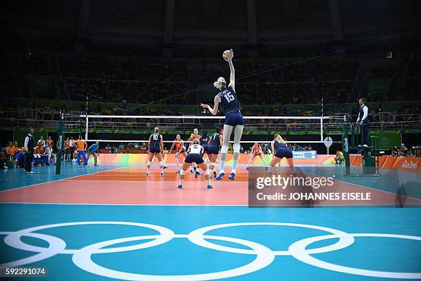 General view shows USA's Kimberly Hill serves the ball during the women's bronze medal volleyball match between the Netherlands and USA at...