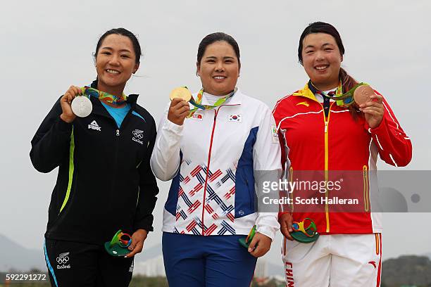 Silver medalist, Lydia Ko of New Zealand, gold medalist, Inbee Park of Korea and bronze medalist Shanshan Feng of China pose on the podium during the...