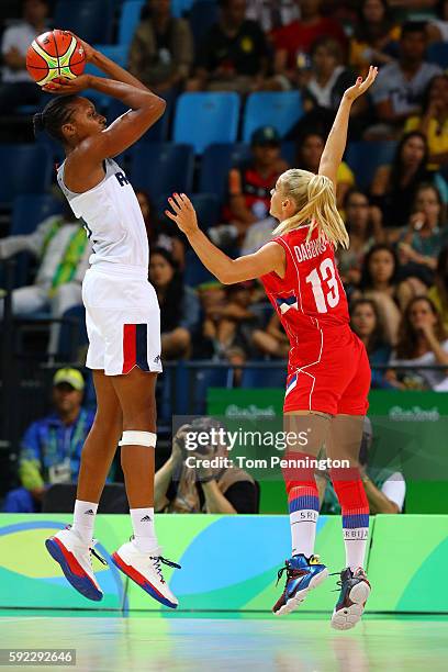 Sandrine Gruda of France shoots against Milica Dabovic of Serbia during the Women's Bronze Medal basketball game between France and Serbia on Day 15...