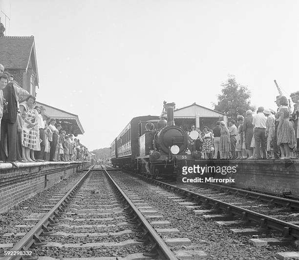 Crowds on the platform at Horsted Keynes station await the arrival of the London, Brighton & South Coast Railway locomotive No. 55 "Stepney", a...