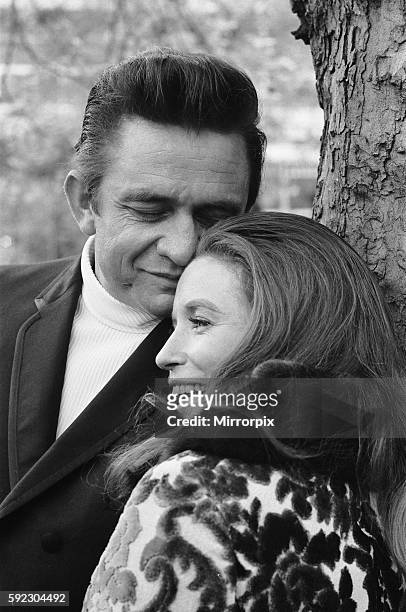 American country singer Johnny Cash with his wife June Carter photographed in a London park during their visit to Britain, a few weeks after their...