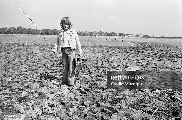 Young boy goes for a spot of fishing at dried out Edgbaston reservoir in Birmingham during the summer heatwave of 1976. 9th August 1976.