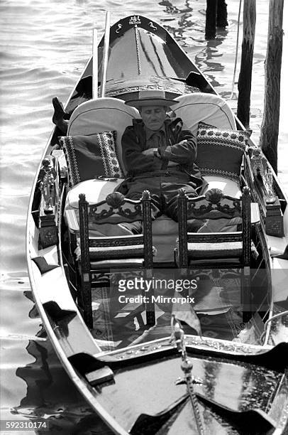 Gondolier catches a quick forty winks between fares on the Grand Canal. April 1975 75-2202-027