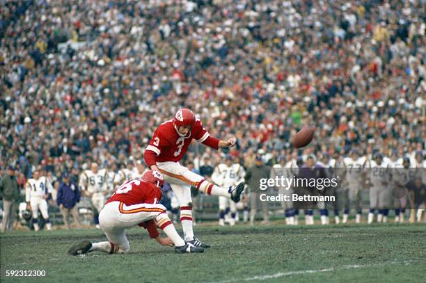 Jan Stenerud of the Kansas City Chiefs kicks a field goal in the second quarter of Super Bowl game against the Minnesota Vikings. Holding for...