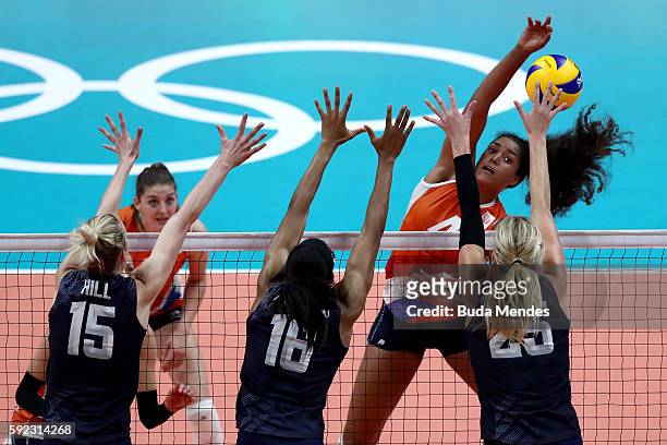 Celeste Plak of Netherlands spikes the ball against Kimberly Hill, Foluke Akinradewo and Karsta Lowe of United States during the Women's Bronze Medal...