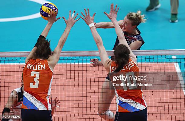 Kimberly Hill of United States spikes the ball against Yvon Belien and Lonneke Sloetjes of Netherlands during the Women's Bronze Medal Match between...