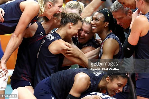 Courtney Thompson, Jordan Larson-Burbach and Foluke Akinradewo of United States celebrate after match point during the Women's Bronze Medal Match...