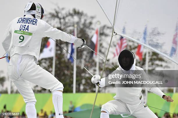 S Nathan Schrimsher and Italy's Riccardo De Luca compete in the fencing portion of the men's modern pentathlon event at the Deodoro Stadium during...