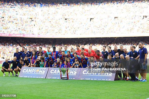 Barcelona players and their families pose with La Liga 2015-16 trophy before the Spanish league football match FC Barcelona vs Real Betis Balompie at...