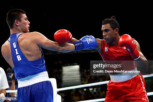 Arlen Lopez of Cuba and Bektemir Melikuziev of Uzbekistan trade blows during the Men's Middle Final Bout on Day 15 of the Rio 2016 Olympic Games at...