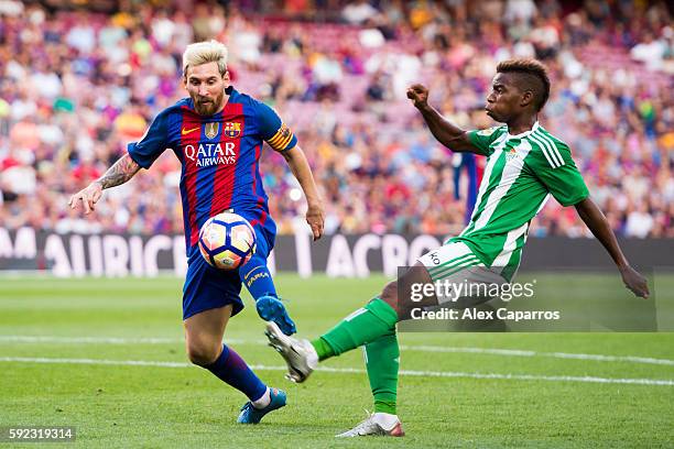 Lionel Messi of FC Barcelona controls the ball next to Charly Musonda of Real Betis Balompie during the La Liga match between FC Barcelona and Real...