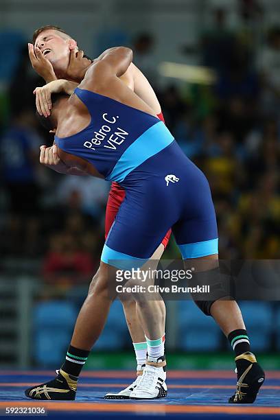 Istvan Vereb of Hungary and Pedro Francisco Ceballos Fuentes of Venezuela compete during the Men's Freestyle 86kg Repechage on Day 15 of the Rio 2016...