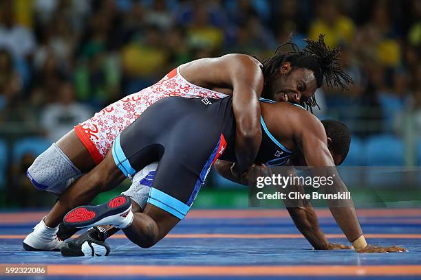 Jaime Yusept Espinal of Puerto Rico and Reineris Salas Perez of Cuba compete during the Men's Freestyle 86kg Repechage on Day 15 of the Rio 2016...