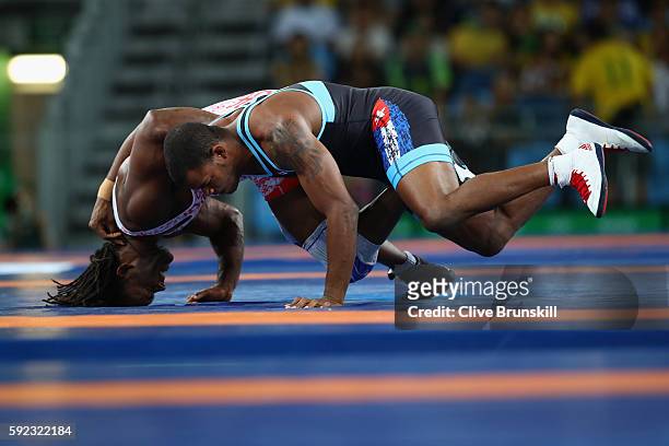Jaime Yusept Espinal of Puerto Rico and Reineris Salas Perez of Cuba compete during the Men's Freestyle 86kg Repechage on Day 15 of the Rio 2016...