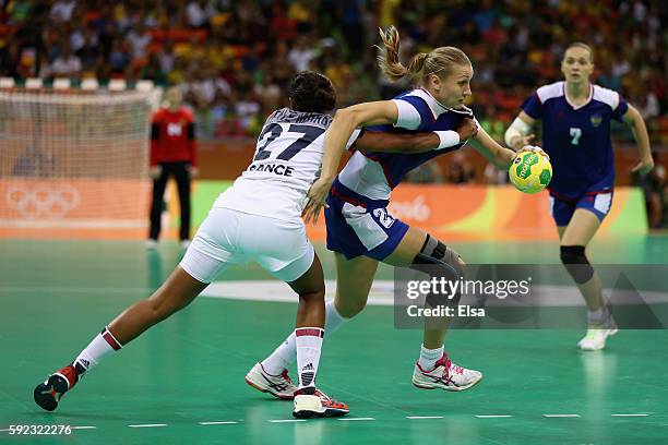 Irina Bliznova of Russia in action against Estelle Nze-Minko of France during the Women's Handball Gold medal match between France and Russia at...