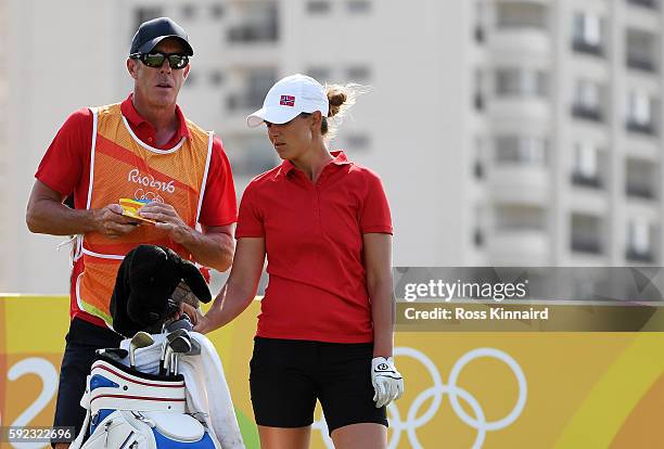 Caddie for Marianne Skarpnord of Norway, European Tour player Richard Green looks on from the eighth tee during the Women's Golf Final on Day 15 of...