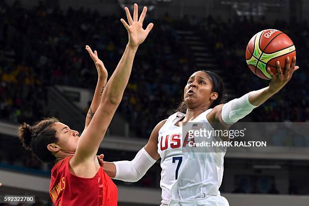 S forward Maya Moore goes to the basket against Spain's power forward Laura Nicholls during a Women's Gold medal basketball match between USA and...