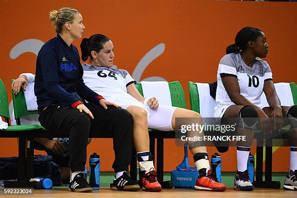 France's right back Alexandra Lacrabere sits on the bench after injury during the women's Gold Medal handball match France vs Russia for the Rio 2016...