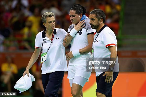 Alexandra Lacrabere of France leaves the pitch after picking up an injury during the Women's Handball Gold medal match between France and Russia at...