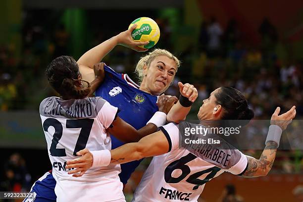Anna Sen of Russia takes a shot under pressure of Estelle Nze-Minko of France and Alexandra Lacrabere of France during the Women's Handball Gold...