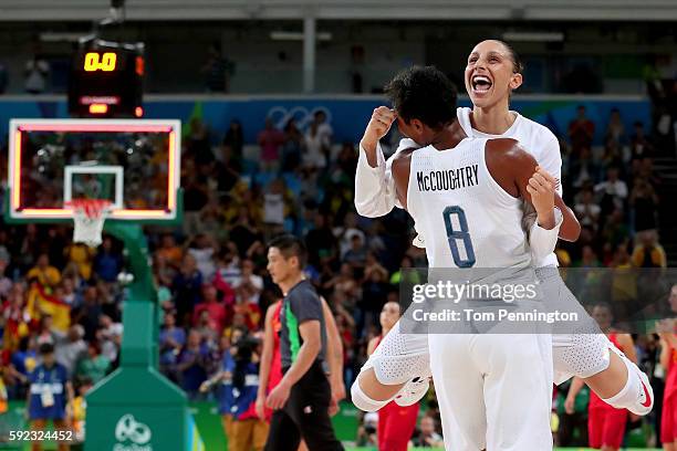 Angel Mccoughtry and Diana Taurasi of United States celebrate after winning the Women's Gold Medal Game between United States and Spain on Day 15 of...