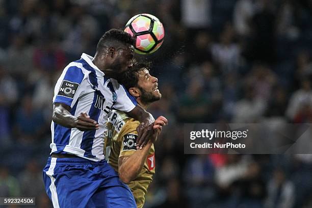 Porto's Portuguese forward Silvestre Varela jumps for a ball with Estoril´s Portuguese defender Joel during the Premier League 2016/17 match between...