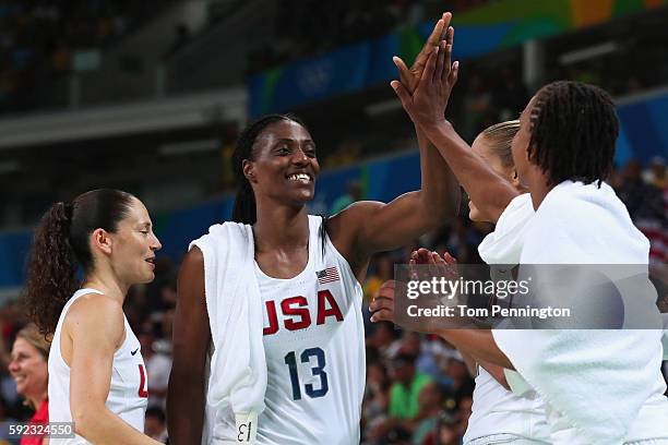 Sue Bird, Sylvia Fowles, and Tamika Catchings of United States celebrate after winning the Women's Gold Medal Game between United States and Spain on...