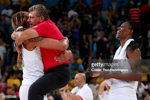 Brittney Griner, head coach Geno Auriemma and Sylvia Fowles of the United States celebrate winning the Women's Gold Medal Game between United States...