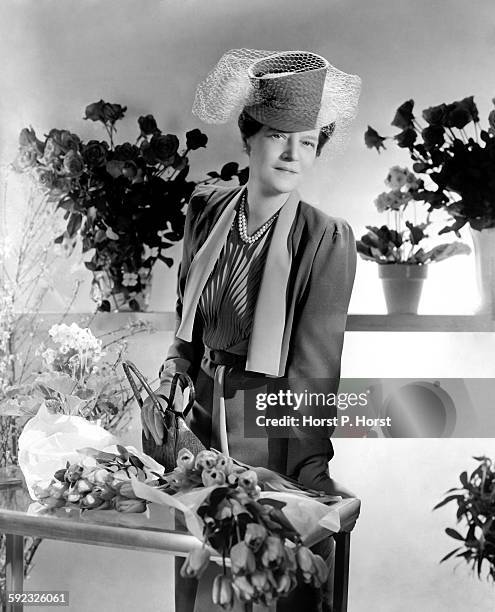 Grand Duchess Marie, cousin to last czar of Russia, wearing gray dress of her own design, surrounded by flowers