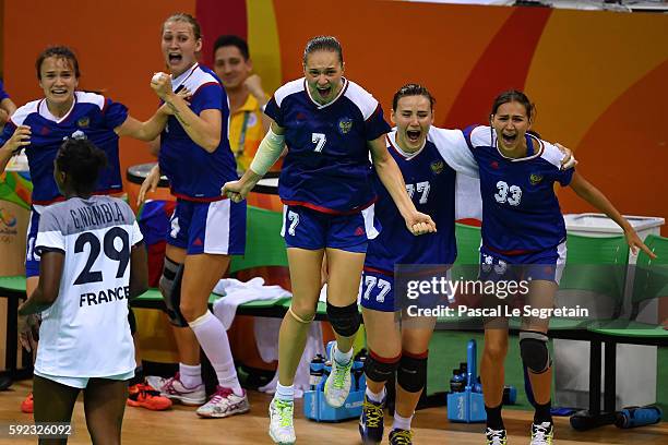Players of Russia celebrate their victory during the women's Gold Medal handball match France vs Russia for the Rio 2016 Olympics Games at the Future...
