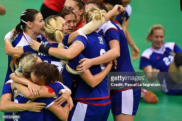 Players of Russia celebrate their victory during the women's Gold Medal handball match France vs Russia for the Rio 2016 Olympics Games at the Future...
