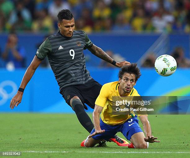 Rodrigo Caio of Brazil and Davie Selke of Germany in action during the Men's Football Final between Brazil and Germany at the Maracana Stadium on Day...