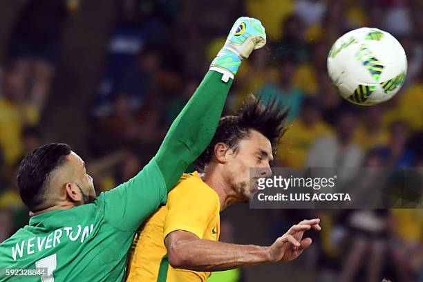 Brazil's defender Rodrigo Caio clashes with Brazil's goalkeeper Weverton Pereira da Silva during the Rio 2016 Olympic Games men's football gold medal...