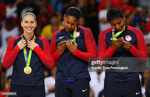 Gold medalists Sue Bird, Maya Moore and Angel Mccoughtry of United States celebrate during the medal ceremony after the Women's Basketball...