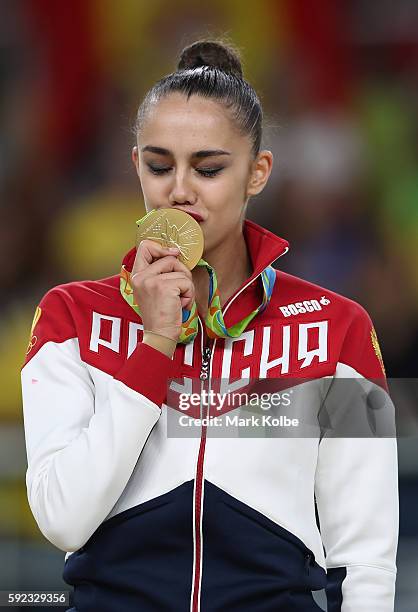 Gold medalist, Margarita Mamun of Russia celebrates on the podium during the Women's Individual All-Around Rhythmic Gymnastics Final on Day 15 of the...