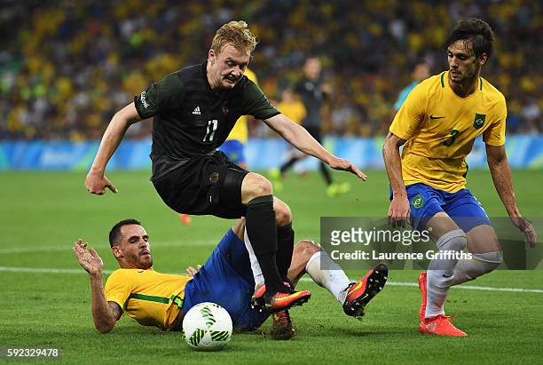 Renato Augusto of Brazil, Julian Brandt of Germany and Rodrigo Caio of Brazil challenge for the ball during the Men's Football Final between Brazil...