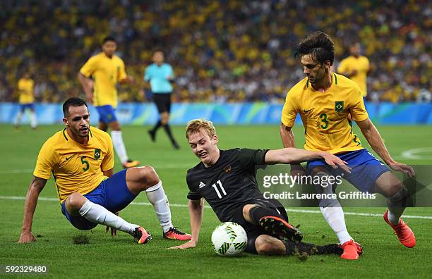 Renato Augusto of Brazil, Julian Brandt of Germany and Rodrigo Caio of Brazil challenge for the ball during the Men's Football Final between Brazil...