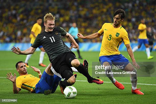 Renato Augusto of Brazil, Julian Brandt of Germany and Rodrigo Caio of Brazil challenge for the ball during the Men's Football Final between Brazil...