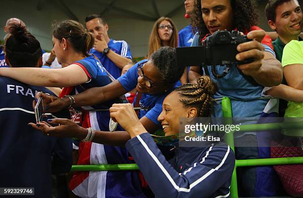 Silver medalist Beatrice Edwige of France celebrates with fans following the medal ceremony for the Women's Handball contest at Future Arena on Day...