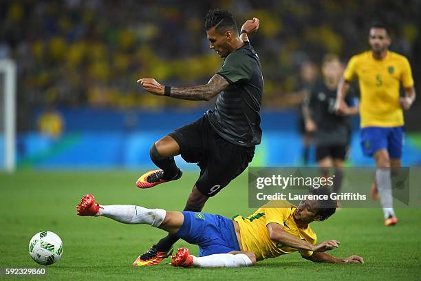 Davie Selke of Germany is challenged by Rodrigo Caio of Brazil during the Men's Football Final between Brazil and Germany at the Maracana Stadium on...