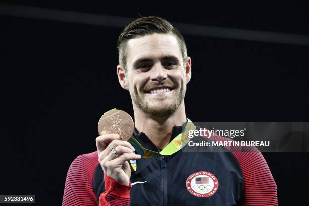 Bronze medallist USA's David Boudia poses during the podium ceremony of the Men's 10m Platform final during the diving event at the Rio 2016 Olympic...