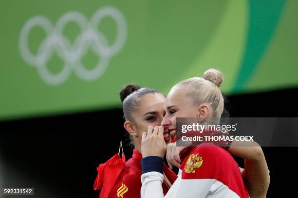 Russia's Yana Kudryavtseva celebrates with Russia's Margarita Mamun and South Korea's Son Yeon Jae after competing in the individual all-around final...
