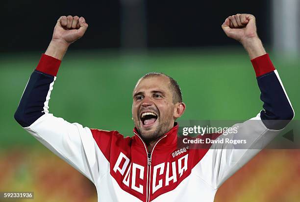 Alexander Lesun of Russia celebrates on the podium befor being presented with his gold medal for the Modern Pentathlon on Day 15 of the Rio 2016...