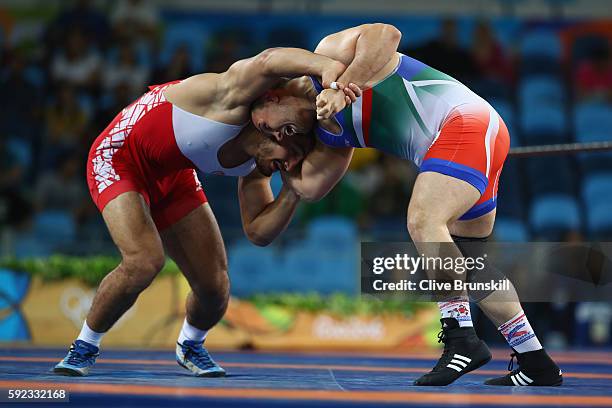 Taha Akgul of Turkey and Komeil Nemat Ghasemi of the Islamic Republic of Iran compete during the Men's Freestyle 125kg Gold Medal bout on Day 15 of...
