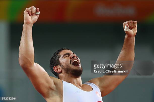 Taha Akgul of Turkey celebrates victory against Komeil Nemat Ghasemi of the Islamic Republic of Iran in the Men's Freestyle 125kg Gold Medal bout on...