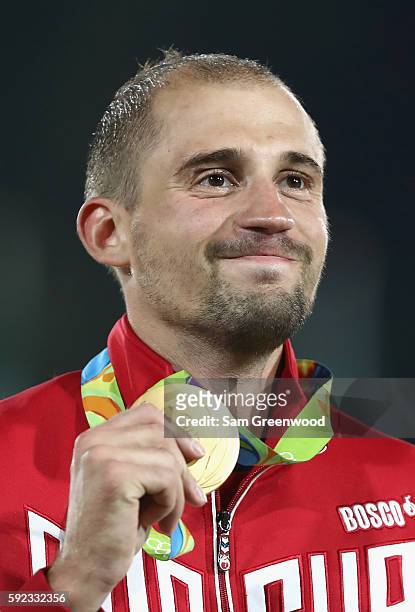 Alexander Lesun of Russia celebrates on the podium with his gold medal for the Modern Pentathlon on Day 15 of the Rio 2016 Olympic Games at Deodoro...