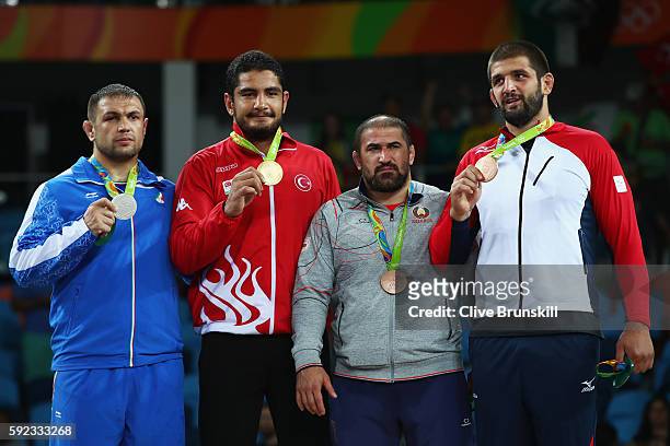 Silver medalist Komeil Nemat Ghasemi of the Islamic Republic of Iran, gold medalist Taha Akgul of Turkey and bronze medalists Ibrahim Saidau of...