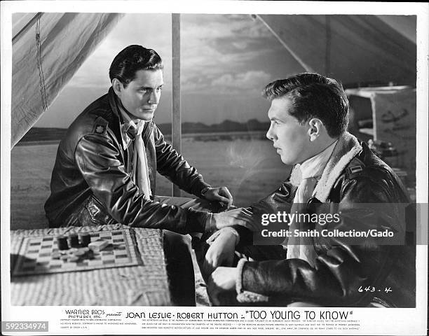 Movie still scene from "Too Young To Know" , a Warner Bros Pictures production, showing two young men in a serious conversation while sitting beside...